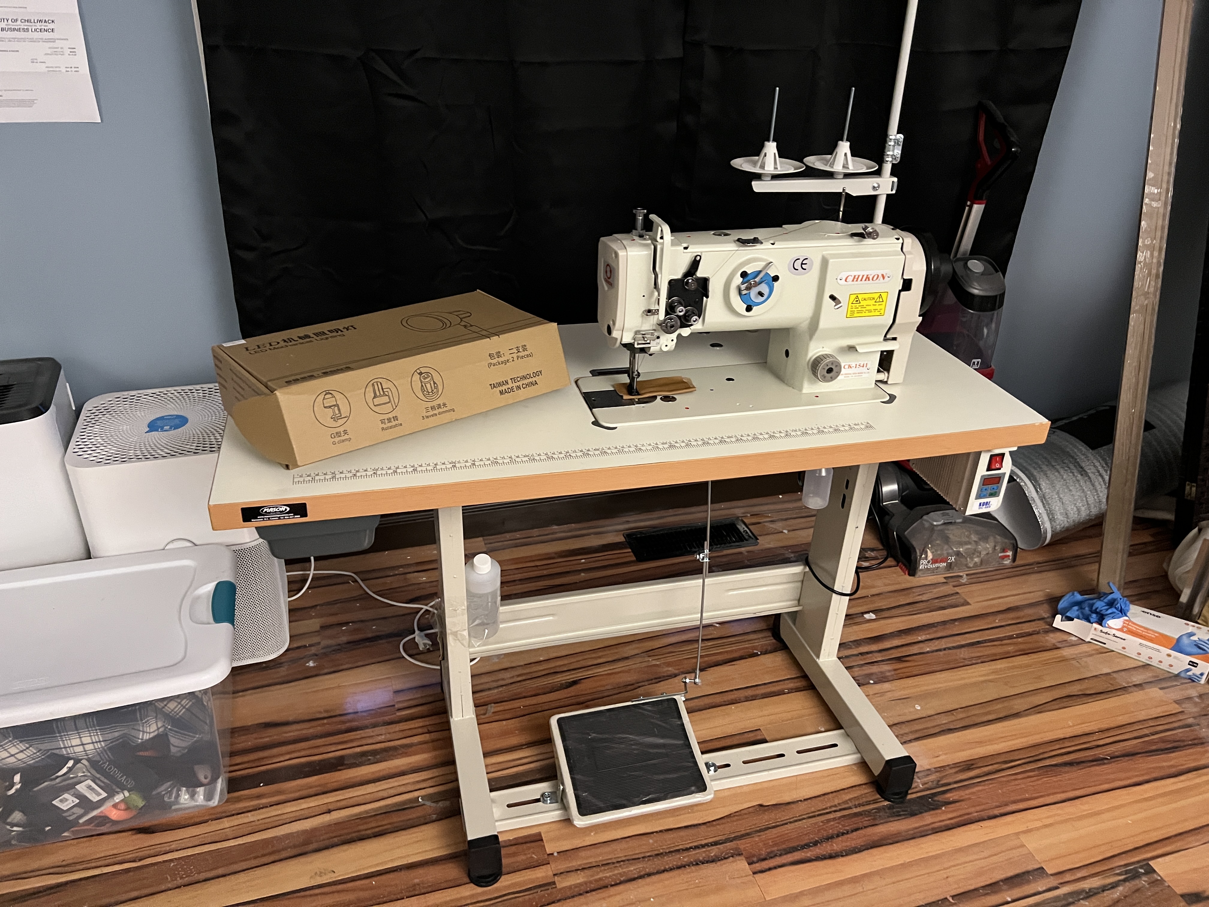 An off-white sewing machine in a workplace