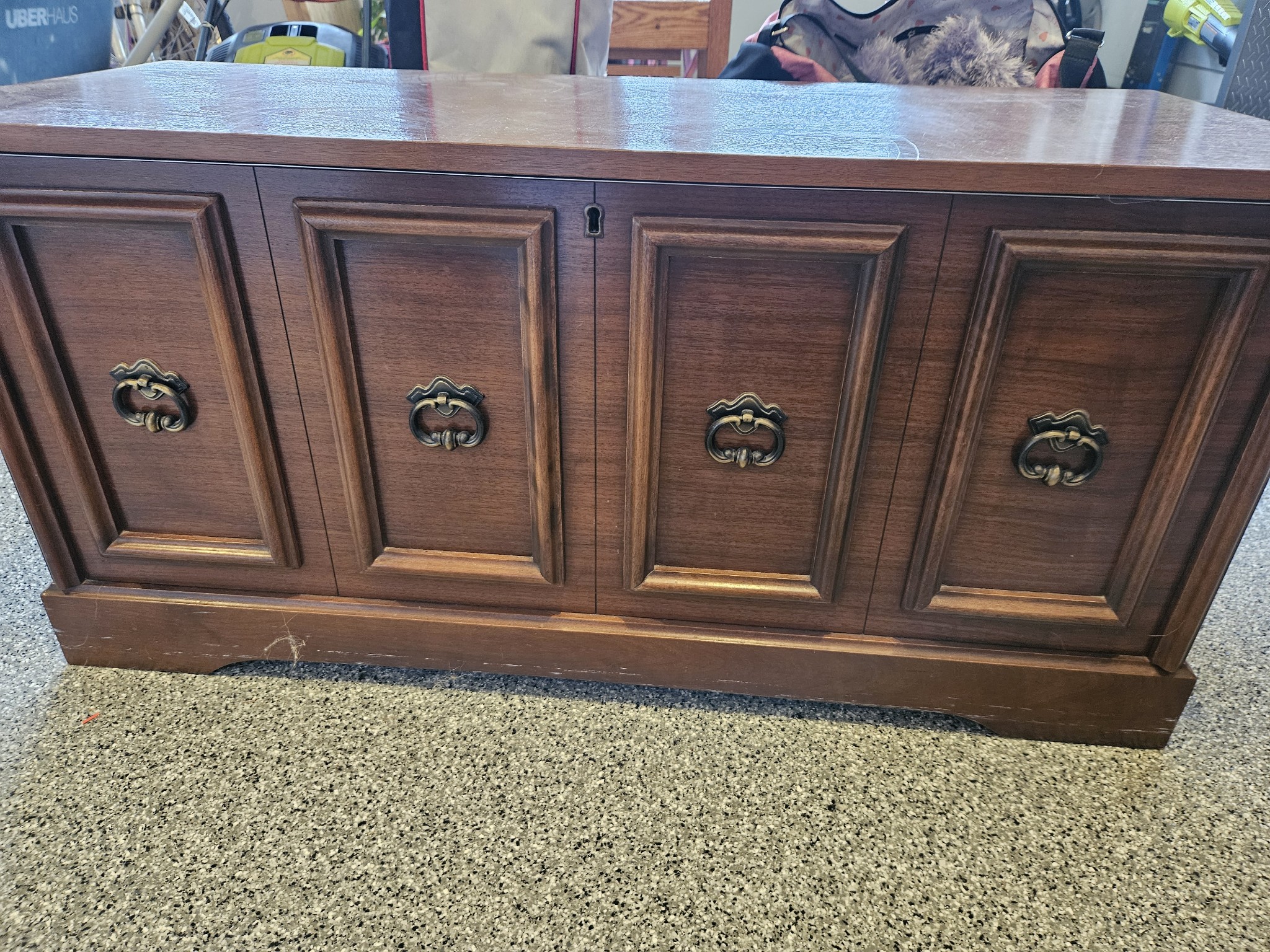 Vintage dark walnut sideboard with four paneled doors and brass ring handles