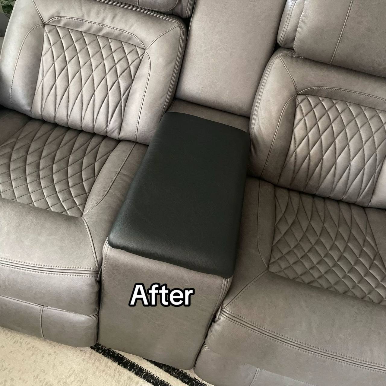 Gray recliner sofa with a center console featuring a wooden table that is upholstered with foam and fabric