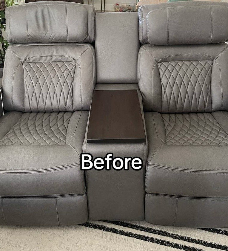 Gray recliner sofa with a center console featuring a wooden table