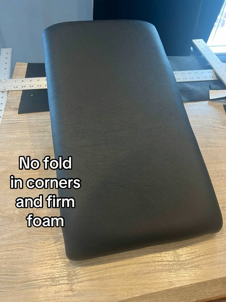 Black upholstered center console armrest