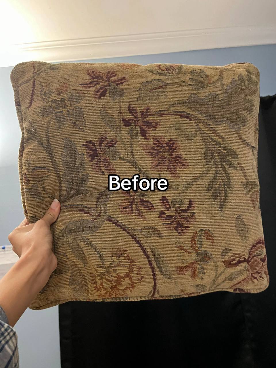 Old sofa cushion with brownish floral fabric cover