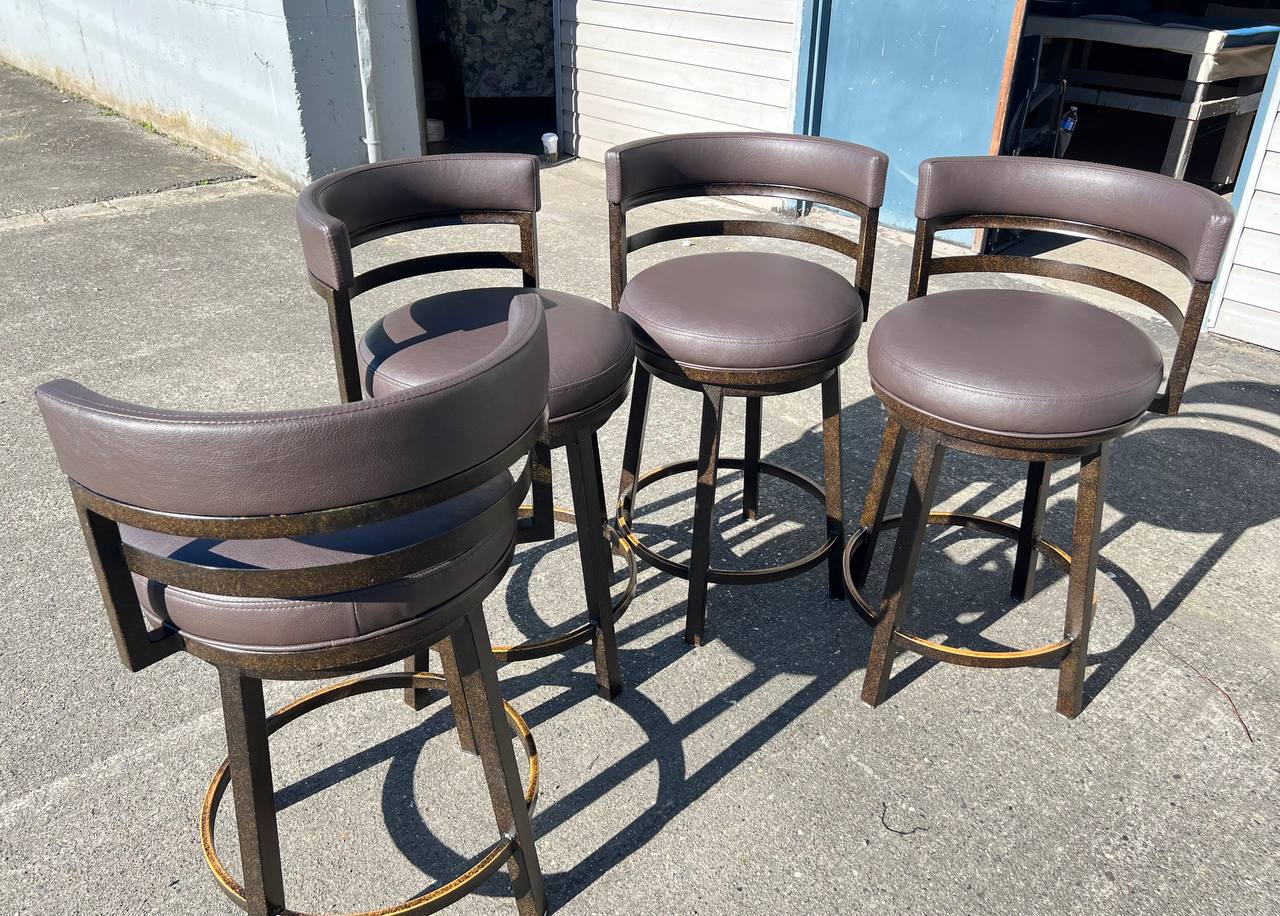 4 Brown leather-like upholstered bar stool with a curved backrest and metal legs in a contemporary design