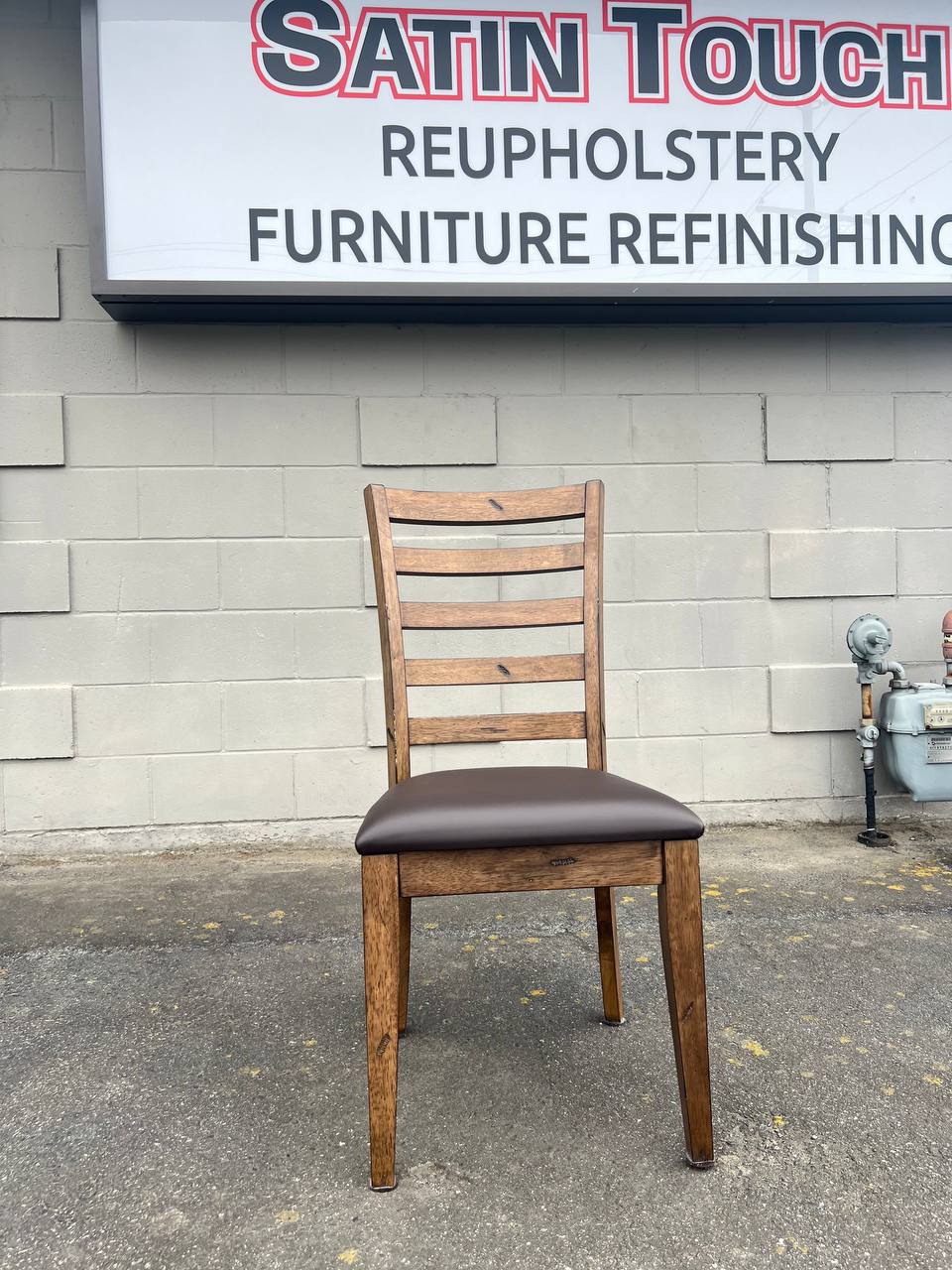 Brown wooden ladder-back chair