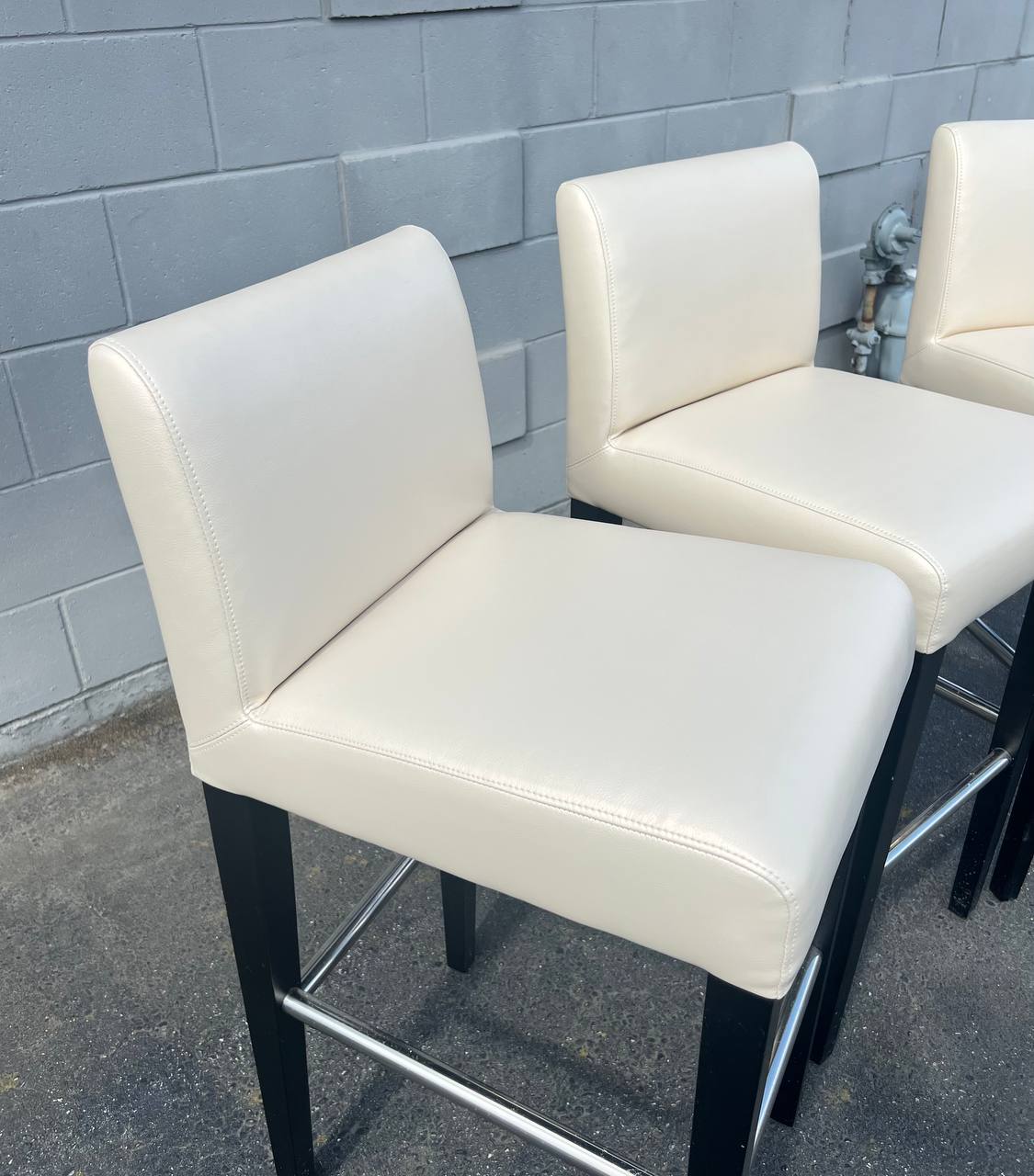 2 Cream colored vinyl barstools