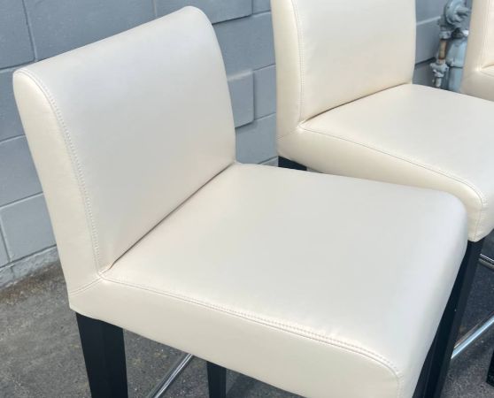 2 Cream colored vinyl barstools