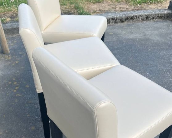 3 Cream colored vinyl barstools