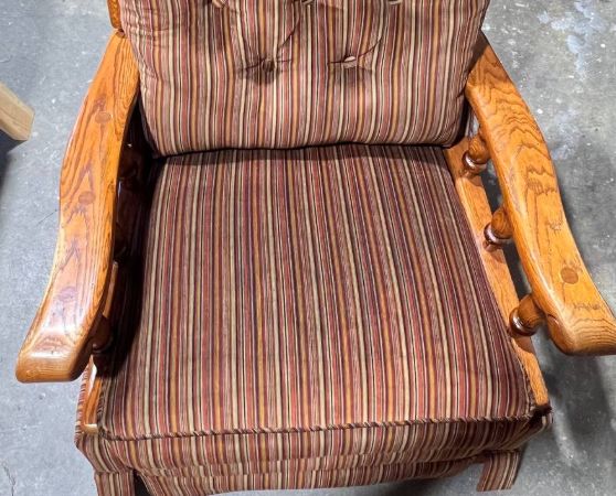 Vintage upholstered wooden armchair with vertical striped fabric in earthy tones and tufted backrest