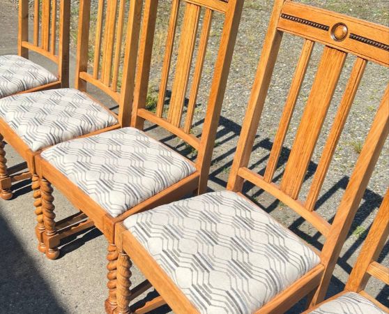 6 dining chairs featuring light wood frames and reupholstered patterned fabric seats