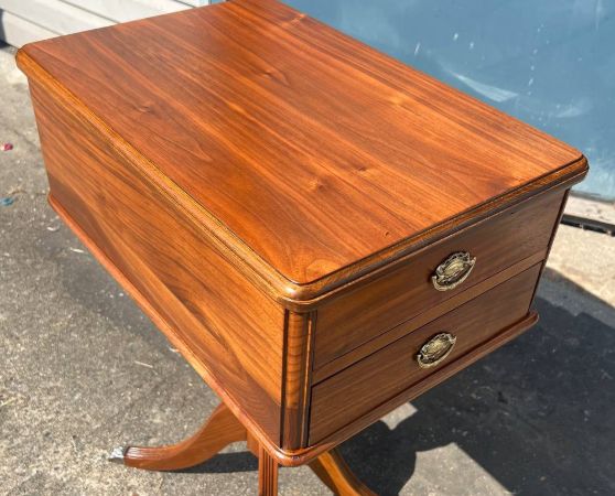 Refinished wooden side table with a rich walnut finish, two brass-accented drawers, and curved pedestal legs featuring metal foot caps