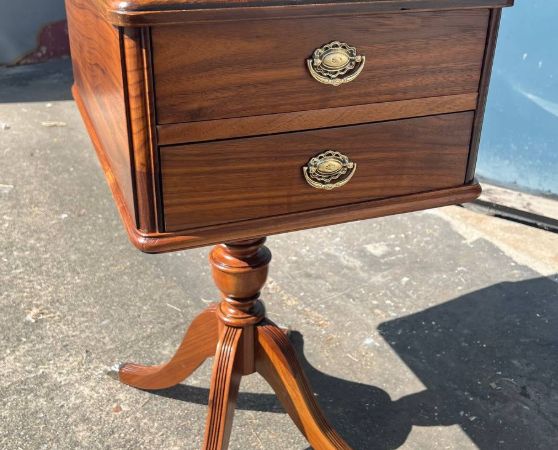 Refinished wooden side table with a rich walnut finish, two brass-accented drawers, and curved pedestal legs featuring metal foot caps