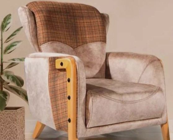 Modern wingback armchair with beige leatherette and brown plaid fabric upholstery, featuring curved wooden arms and tapered legs in natural finish.