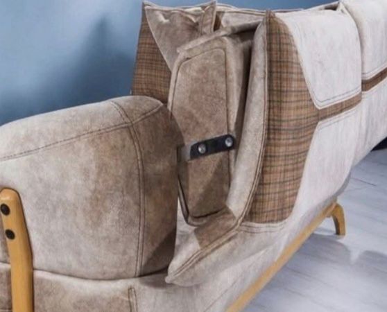 Convertible beige sleeper sofa with brown plaid accents