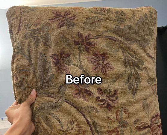 Old sofa cushion with brownish floral fabric cover