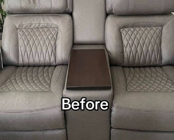 Gray recliner sofa with a center console featuring a wooden table