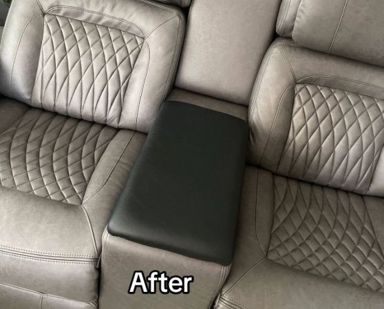 Gray recliner sofa with a center console featuring a wooden table that is upholstered with foam and fabric