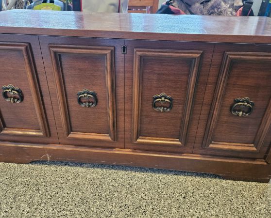 Vintage dark walnut sideboard with four paneled doors and brass ring handles