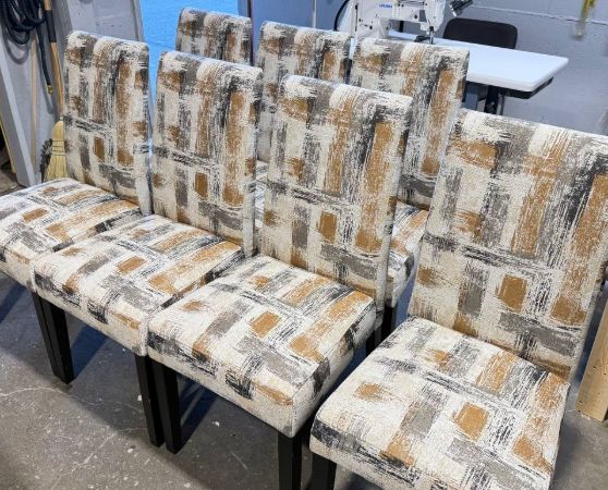 Set of 7 high-back dining chairs with abstract beige, brown, and gray fabric and dark wooden legs.