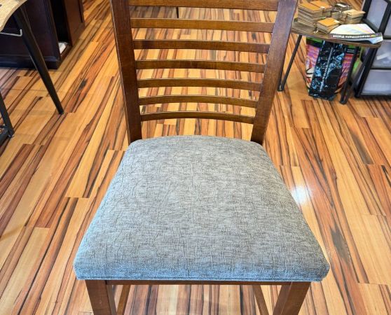 Brown wooden chair with gray cushioned seat, modern slatted design