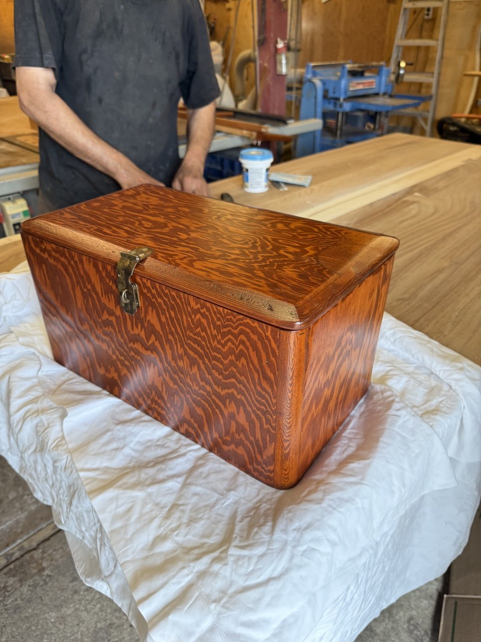 Refinished vintage wooden chest with reddish-brown finish and metal clasp