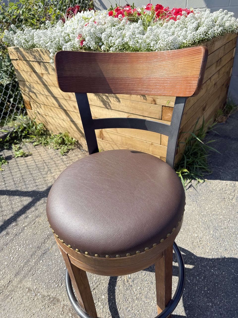Bar stool reupholstered in chocolate brown vinyl  with a new cushion