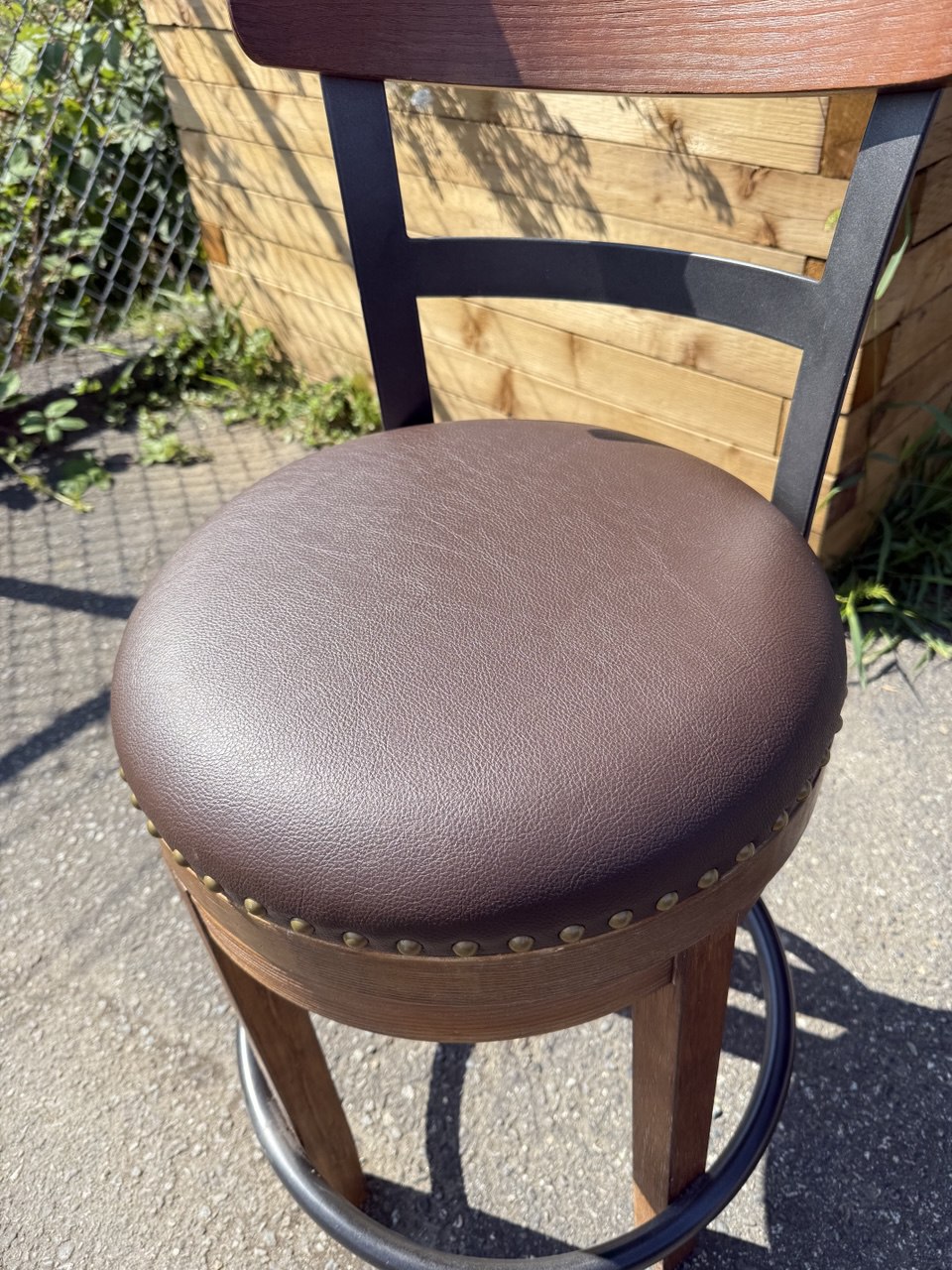 Bar stool reupholstered in chocolate brown vinyl  with a new cushion