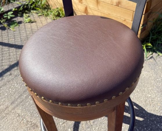 Bar stool reupholstered in chocolate brown vinyl with a new cushion