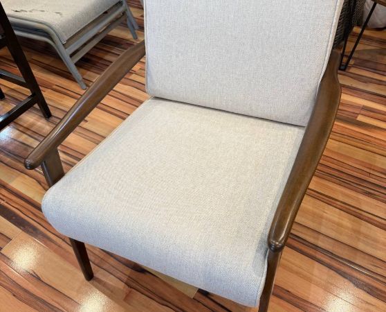 Beige fabric armchair with walnut arms, mid-century style.