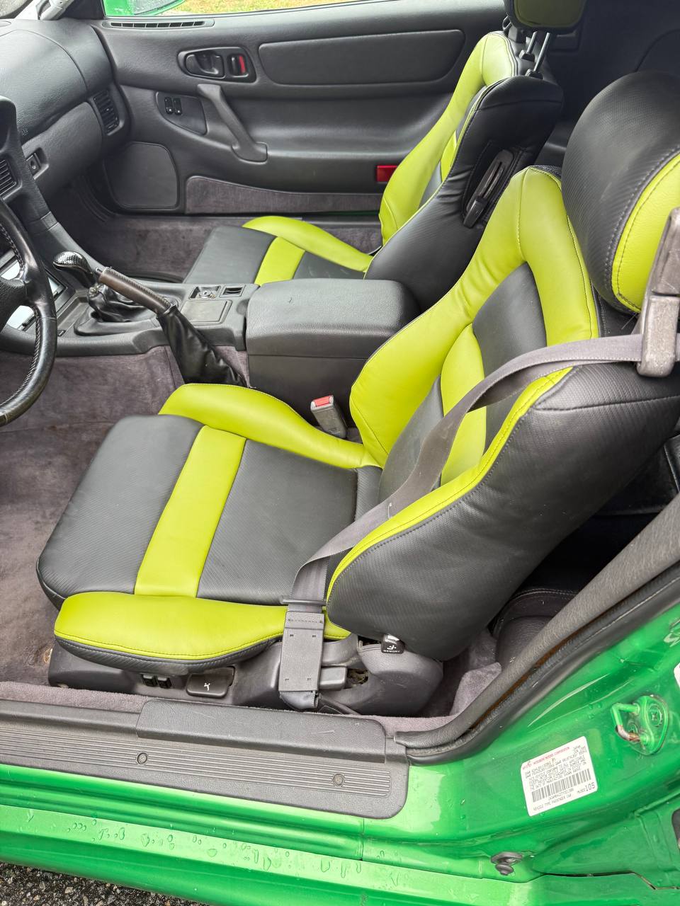 Black and green custom upholstered car seats.