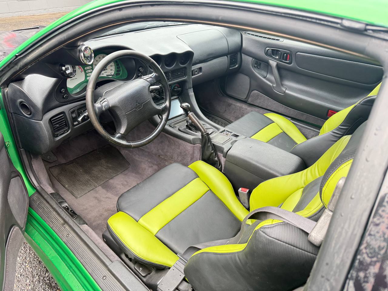 Black and green custom upholstered car seats.