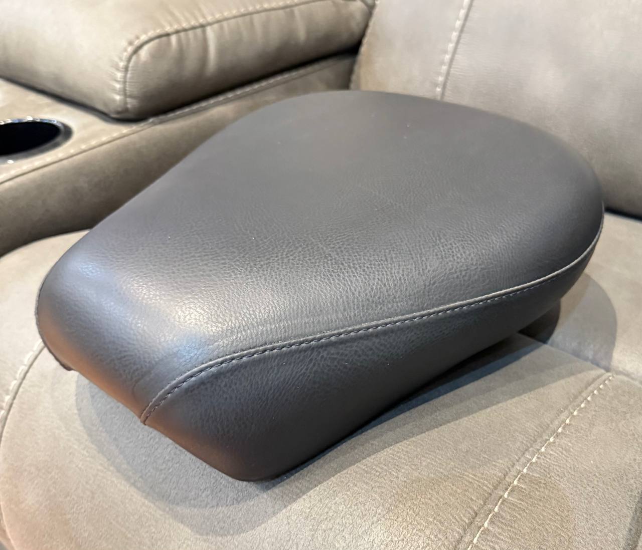 Gray leather motorcycle seat, contoured design.