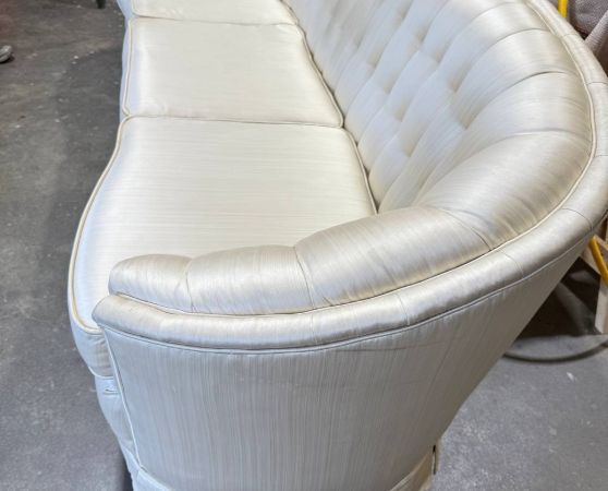 Tufted Chesterfield sofa in white fabric with rolled arms and curved frame