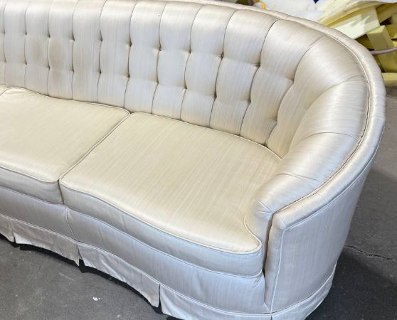 Tufted Chesterfield sofa in white fabric with rolled arms and curved frame