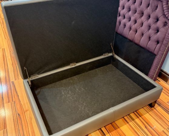 Modern gray storage ottoman, upholstered in sleek fabric with a lift-top design for storage.