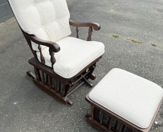 Refinished and reupholstered classic glider rocking chair and ottoman set, featuring cream fabric with tufted detailing.