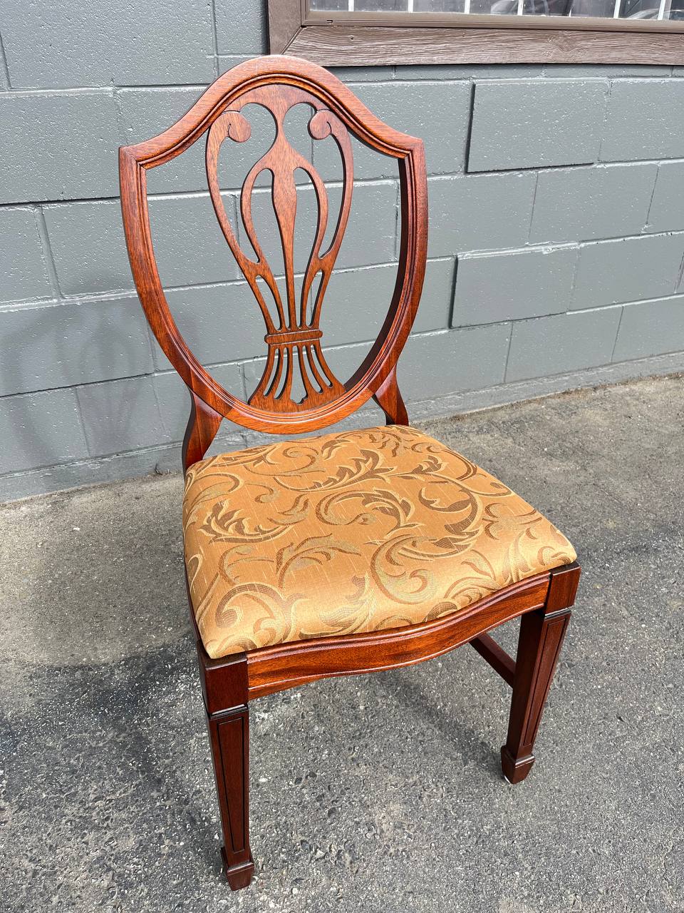 Refinished solid mahogany dining chair with dark brown stain and reupholstered.