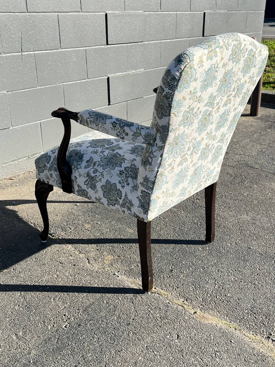 Back of the reupholstered antique chair in white floral pattern