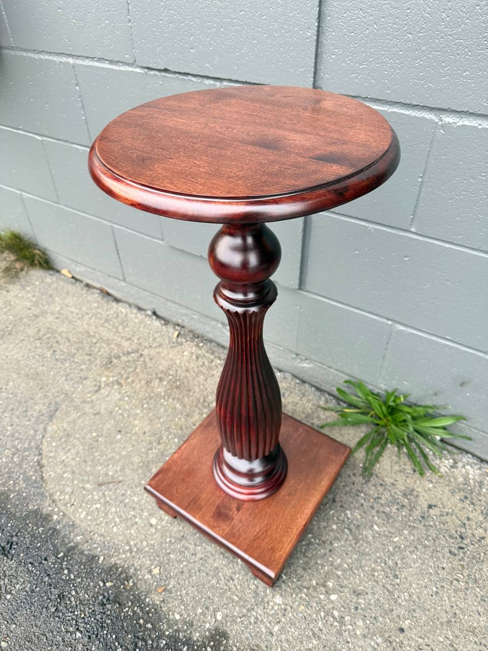 refinished antique pedestal table in reddish brown stain