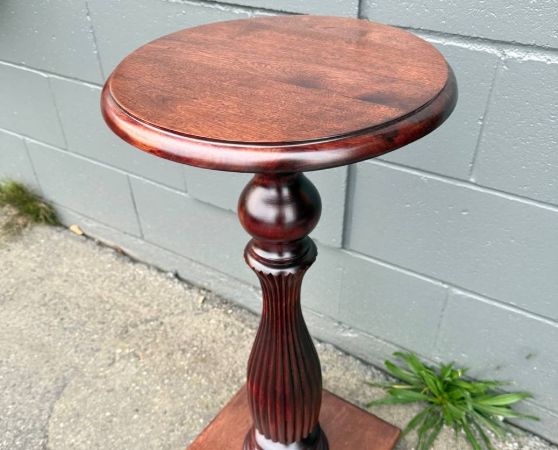 refinished antique pedestal table in reddish brown stain