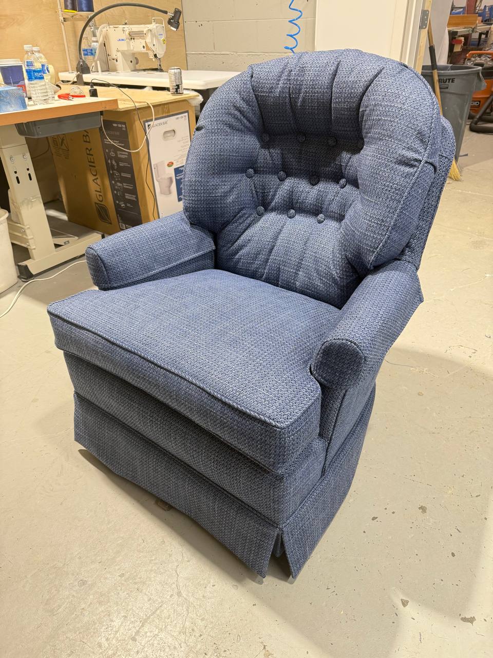 Reupholstered Tufted Swivel Rocking Chair with a skirted base in blueberry fabric