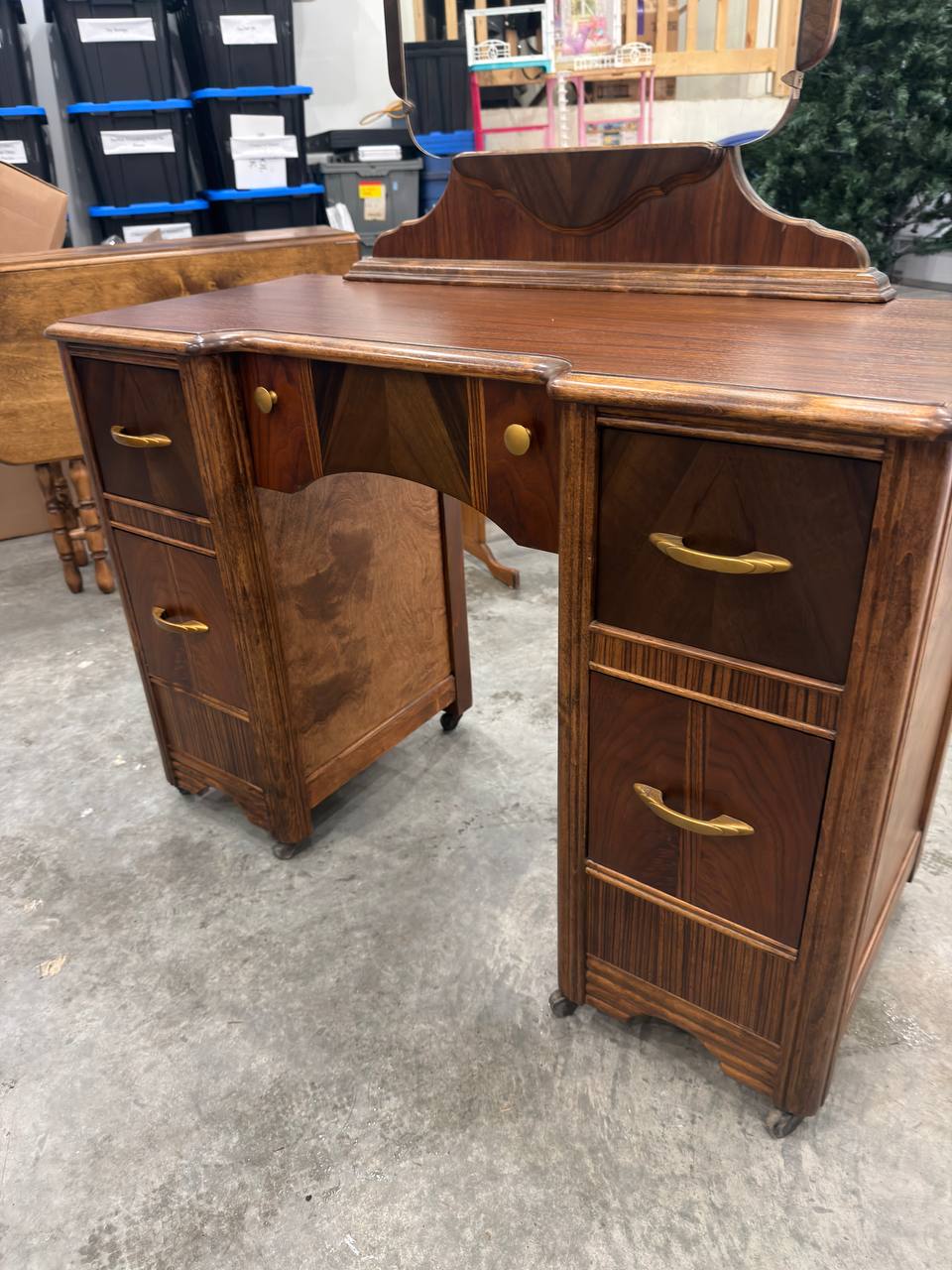 Front of Refinished Waterfall-style Vanity with Mirror and Brass Hardware