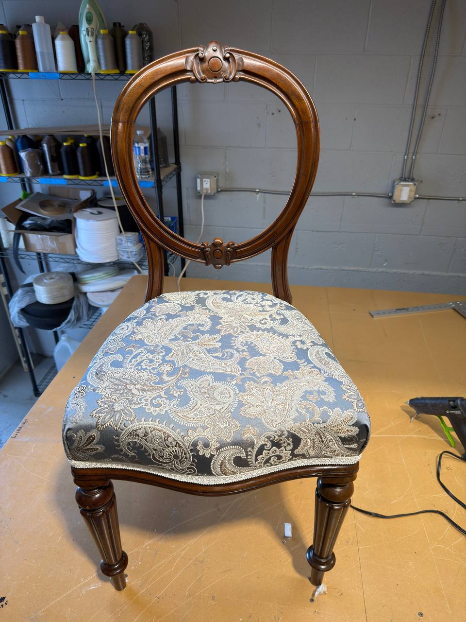 Dining chair reupholstered in blue-grey paisley fabric at Satin Touch
