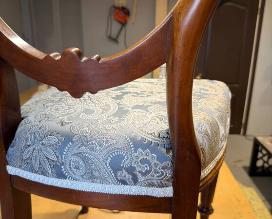 Close-up of paisley chair seat upholstery and decorative trim