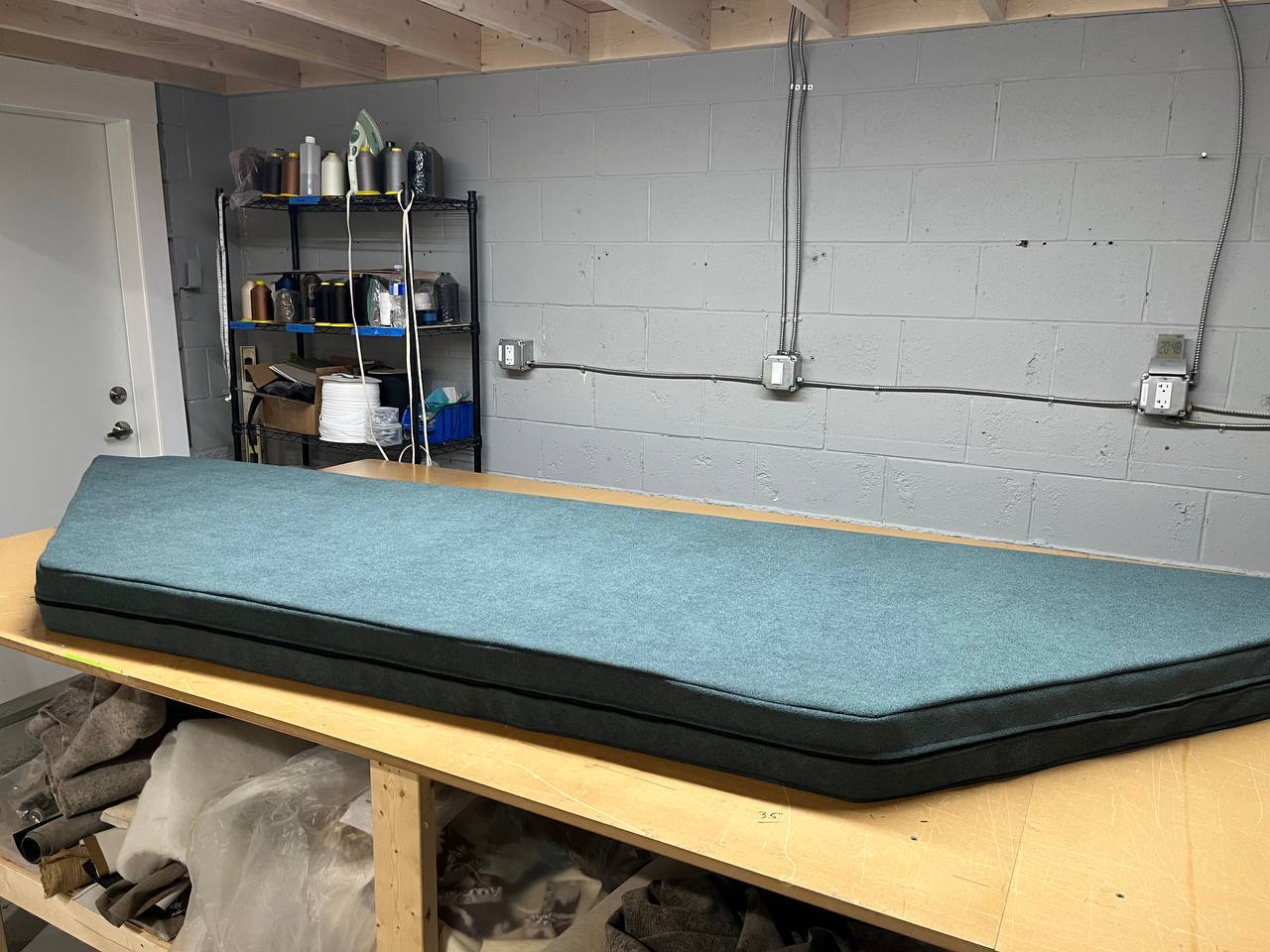Custom teal fitted window-seat cushion made at Satin Touch