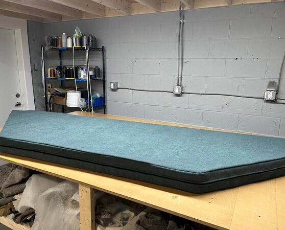 Custom teal window nook cushion with a dark boxed border